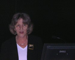 Photo of Chris Mann presenting her paper in a lecture