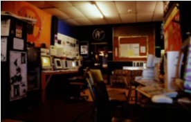 Image of a Sydney media lab, showing a series of computers and various posters on the walls.